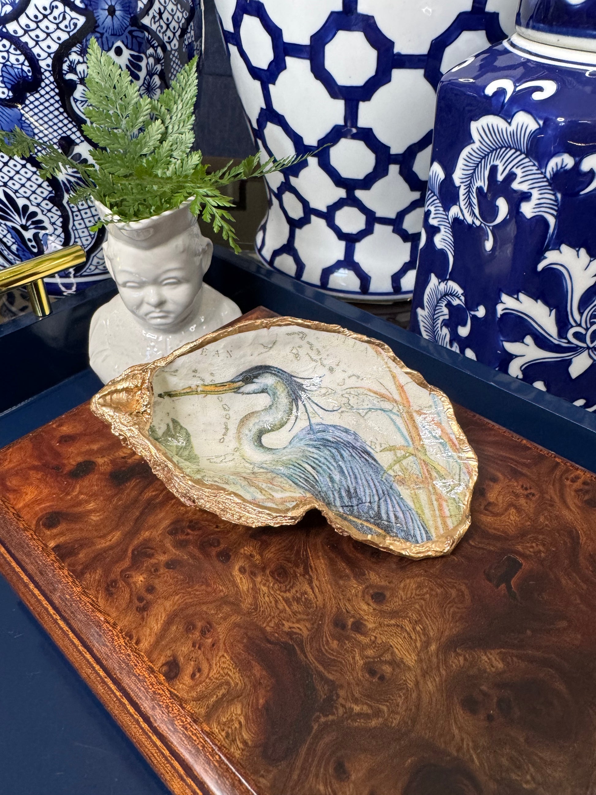 Handcrafted oyster or clam shell titled 'Blue Heron Elegance' featuring grande oyster display shell, bird collection design, shown in a styled product display.
